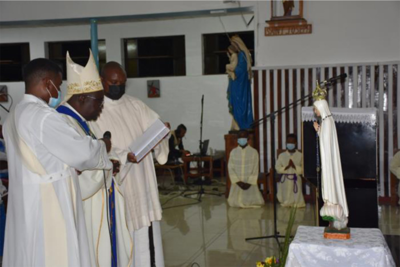 His Grace George Desmond Tambala offering prayers for consecration at the statue of the Blessed Virgin Mary