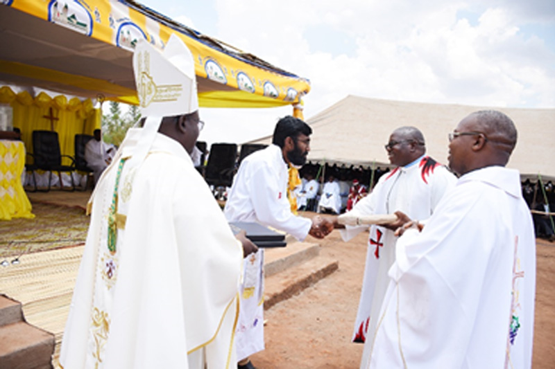 Parish priests of Nambuma and Namitete parishes handing over parish books to the new Parish priest of the new parish in the presence of the Archbishop