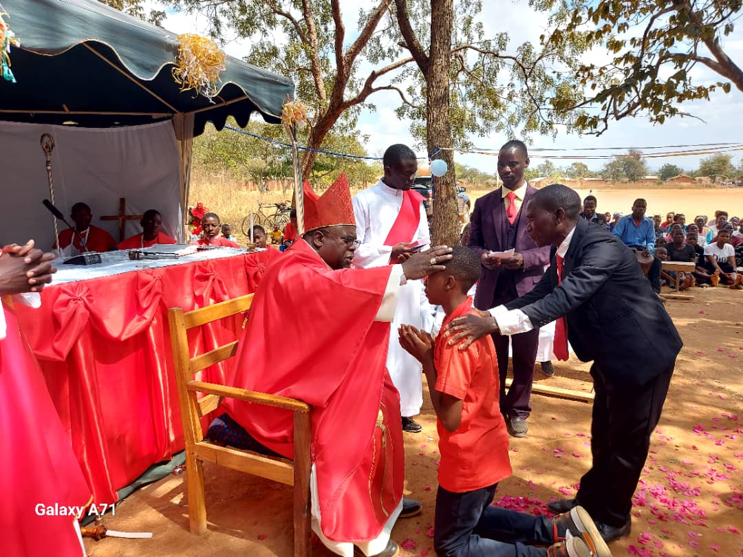 Archbishop George Tambala, his first day at Pinda Zone, administering Sacrament of Confirmation to the adolescents