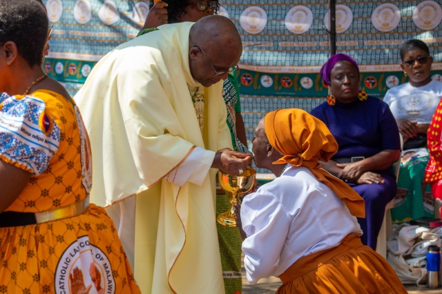 Bishop Gabriel Msipu Phiri giving the Eucharist on the tongue