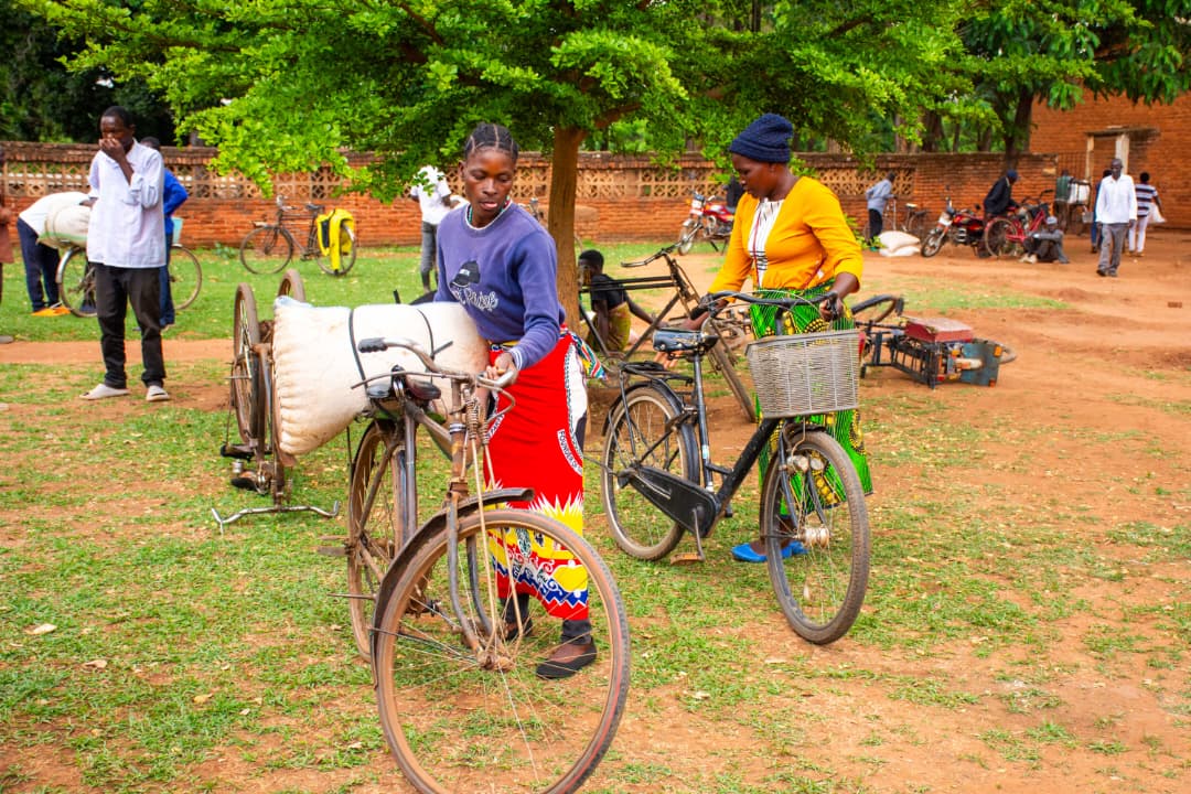A woman ferrying her bag on a bicycle