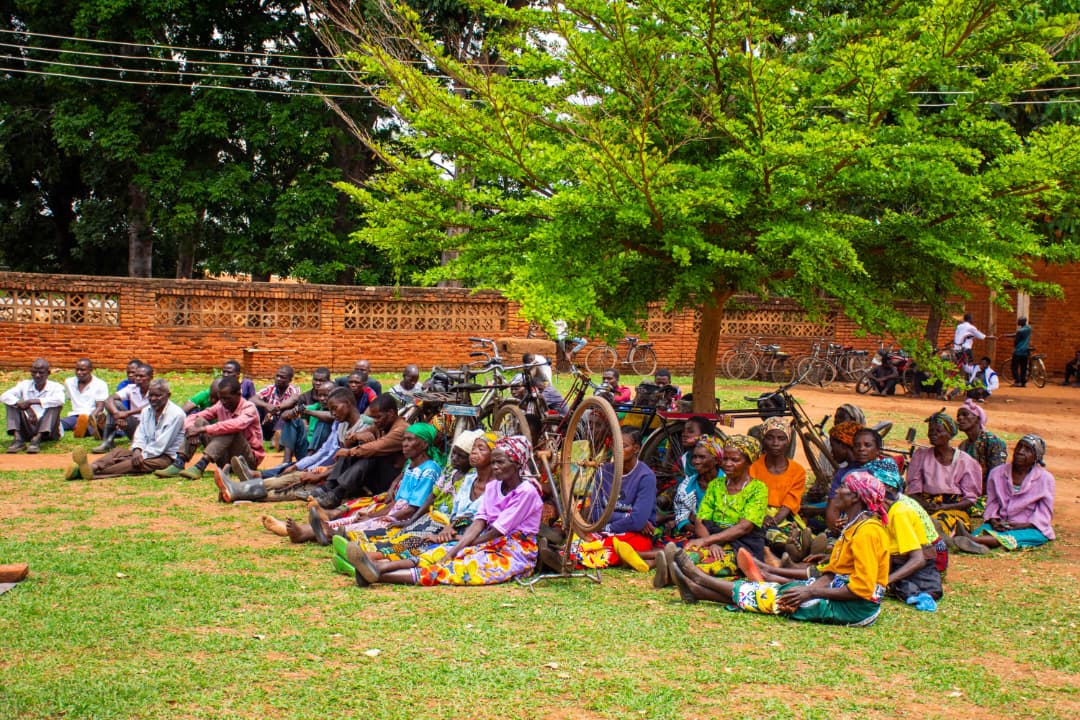 Affected people await their turn to receive a 50kg bag of maize