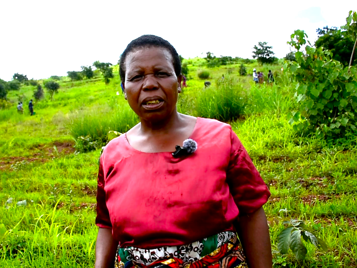 Felesitiya Chunga of the Banja Loyera Small Christian Community stands by the newly prepared planting site
